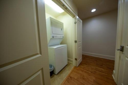 an empty room with a kitchen with a microwave at Inshore Paradise Steps from the marsh 