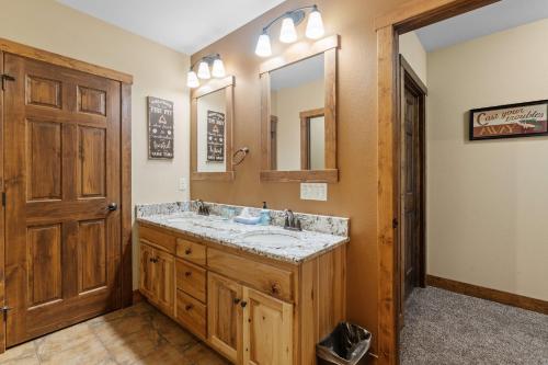 a bathroom with a sink and a mirror at Sleep 12-big Sandy Lodge V10-lakefront-luxury in McGregor