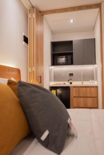a black pillow sitting on a bed in a room at Autenthico Local Stay Hotel Envigado in Envigado