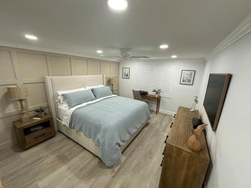 a bedroom with a bed and a table in it at 2 BR Condo in St Augustine across from Beach in Saint Augustine