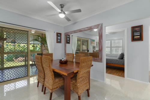 a dining room with a wooden table and chairs at Dolphin Cove - Pet Friendly with Fireplace in Callala Bay
