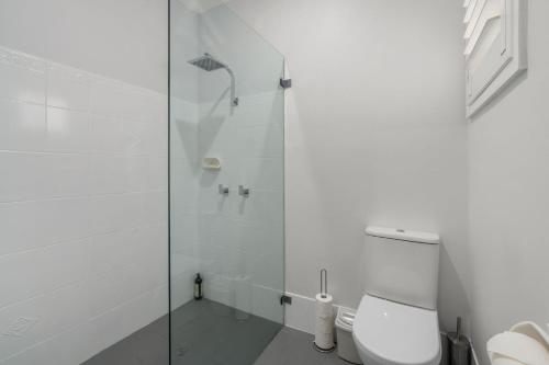 a bathroom with a shower and a toilet at Dolphin Cove - Pet Friendly with Fireplace in Callala Bay