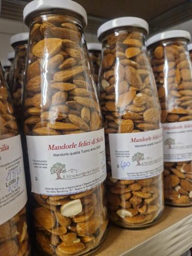 a group of jars filled with nuts on a shelf at Agriturismo Il Respiro del Bosco in San Piero in Bagno