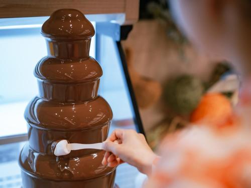 a person is holding a piece of chocolate at Kinugawa Hotel Mikazuki in Nikko