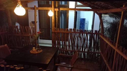 comedor con mesa, sillas y luces en Kusum Family House, en Dikwella