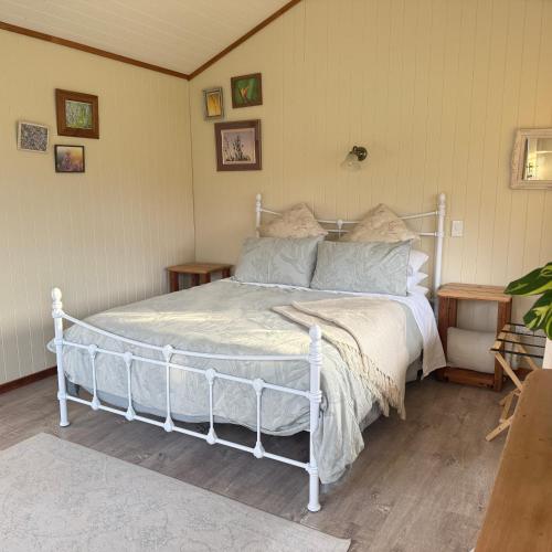 a bedroom with a white bed in a room at Wisteria Way in Opononi
