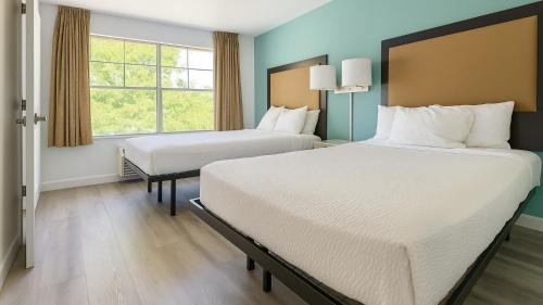 Ένα ή περισσότερα κρεβάτια σε δωμάτιο στο MainStay Suites Las Vegas Flamingo
