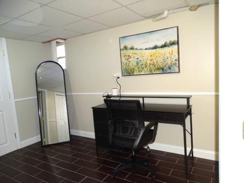 a room with a desk and a painting on the wall at Comfortable Renovated 3 Bed Apartment in Framingham