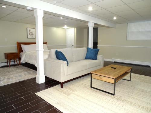 a living room with a couch and a bed at Comfortable Renovated 3 Bed Apartment in Framingham
