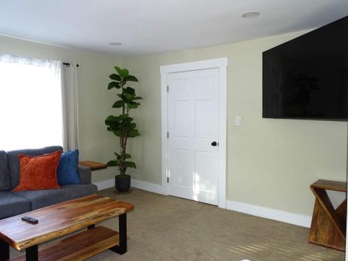 a living room with a couch and a table at Comfortable Renovated 3 Bed Apartment in Framingham