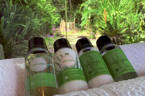 a group of three bottles of soap on a table at Casa Container 80 in Campos do Jordão