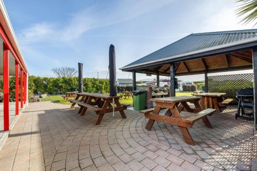a group of picnic tables on a patio at Kaikōura TOP 10 Holiday Park in Kaikoura