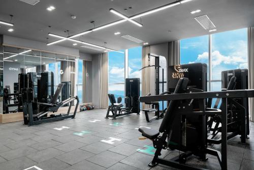 a gym with treadmills and exercise equipment in a building at MAISON SEAFRONT RESIDENCE Nha Trang in Nha Trang