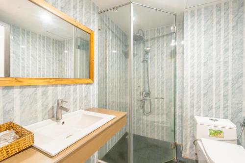 a bathroom with a sink and a shower at Golden Daisy Hotel Phu Quoc in Phu Quoc