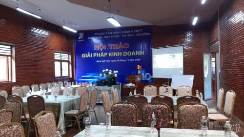 a conference room with tables and chairs and a sign at Orchard Home Nam Cat Tien in Cat Tien