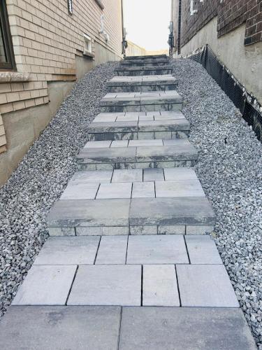 a row of stone steps next to a building at Rita's Kunjo - 2BR, 3BD, 2WR, Full Ktchn, Living in Whitby