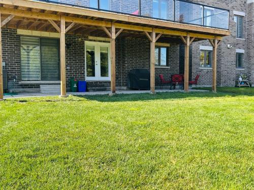 a porch of a brick house with a patio at Rita's Kunjo - 2BR, 3BD, 2WR, Full Ktchn, Living in Whitby
