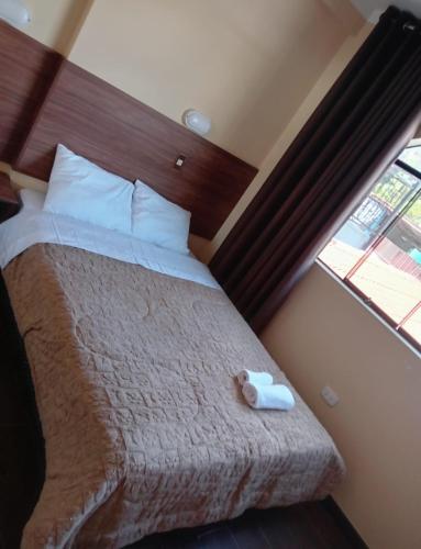 a bedroom with a bed with a stuffed animal on it at Alojamiento Casca in Huaraz
