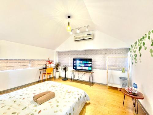 a bedroom with a bed and a flat screen tv at Ding Doong 2nd Homes in Hanoi