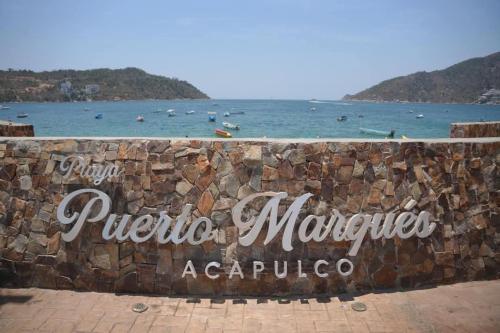 a sign for puerto margarita margaritaendas acapulco at Casa Blanca Puerto Marqués 10 in Acapulco