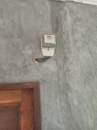 a room with a wall with a electrical device on it at Lantacocogarden in Ko Lanta Yai