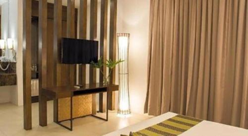 a hotel room with a television and a bed at Ciriaco Hotel in Calbayog City