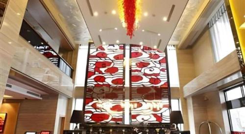 a room with a large chandelier in a building at The Prosperous City Hotel Weifang in Weifang