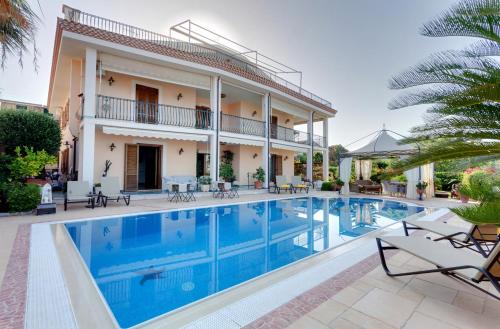an image of a villa with a swimming pool at La Suite del Faro in Scalea