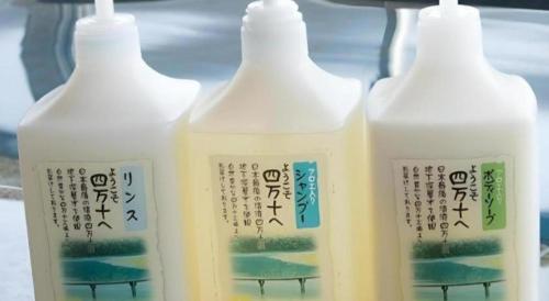 three bottles of milk sitting on a shelf at Nest West Garden Tosa Hotel in Shimanto