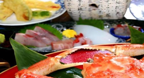 a plate of food on a table with sushi at Otaiko Hills in Fukui