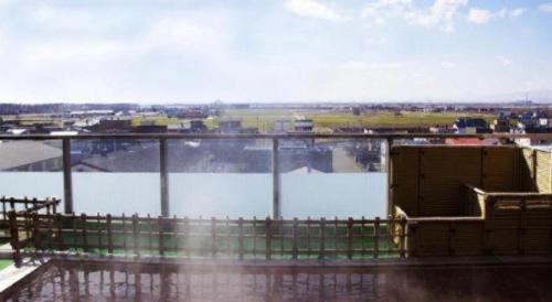 a view of a body of water with a fence at Hokkaido Futomi Meisen Manyo no Yu in Sapporo