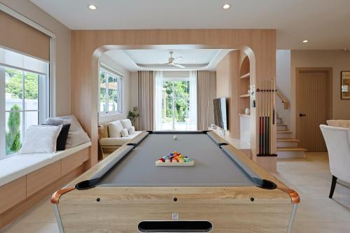 a living room with a pool table in it at White Wood Family Villa, 5 Kingbeds, 12 mins airport in Chiang Mai