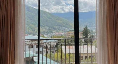 a window with a view of a mountain at Khang Residency Thimphu in Thimphu
