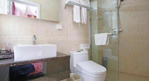 a bathroom with a toilet and a sink and a shower at TO915101 STILL LOVE THEME HOTEL in Chengdu