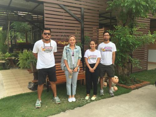 a group of people standing in front of a house at Baan Ing Daan in Amnat Charoen