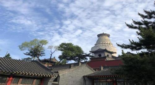 a building with a tower on top of it at IU Hotels Xinzhou Bus Terminal in Xinzhou