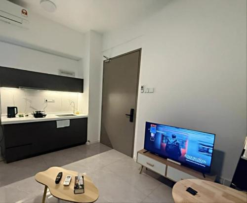 a living room with a television and a kitchen at Bay Suites Likas - 沙巴民宿 - 3 Min to KK City - Sea View 21-19 in Kota Kinabalu
