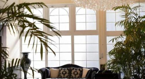 a living room with a couch and a large window at HOTEL FUTARI KOMOREBI in Atami
