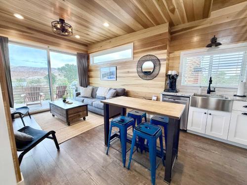 a kitchen and living room with a table and chairs at Escalante Escapes Desert Willow- Loft Escape in Escalante