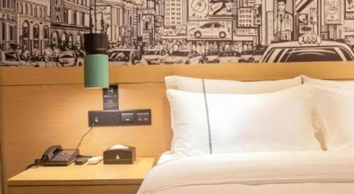 a hotel room with a bed and a phone and a bed gmaxwell gmaxwell gmaxwell gmaxwell at City Comfort Inn Wuhan International Expo Center Yongwang in Wuhan