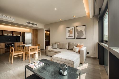 a living room with a couch and a table at Namóra by Lumina in Guadalajara