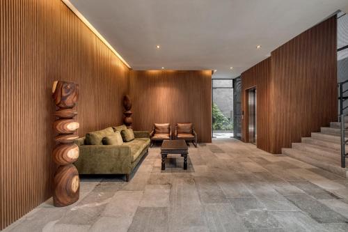 a living room with a couch and a stair case at Namóra by Lumina in Guadalajara