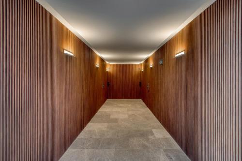 a hallway with wooden walls and a tile floor at Namóra by Lumina in Guadalajara