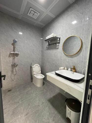 a bathroom with a sink and a toilet and a mirror at Snu Motel - Cao Bằng in Cao Bằng