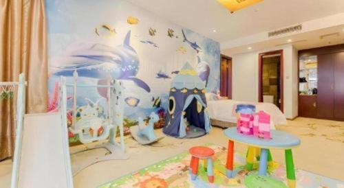 a childs bedroom with a mural of a dolphin at VX Hotel Chengdu Jiaolong Port Haibin in Chengdu