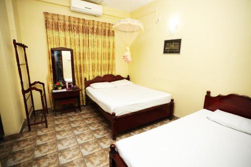 Postel nebo postele na pokoji v ubytování Kandy Paradise Resort & Spa