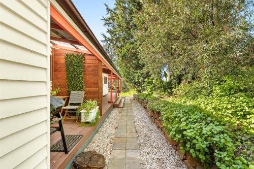 a garden path next to a house at Central Tilba Overnight Retreat ! King Bed, Ensuite, Pet-Friendly in Central Tilba