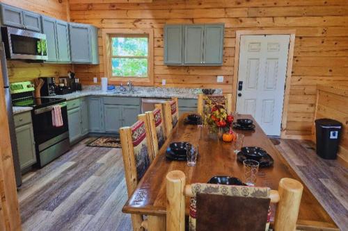 a kitchen with a long wooden table in a cabin at Misty Mountain View - 2 bedroom cabin in Glade