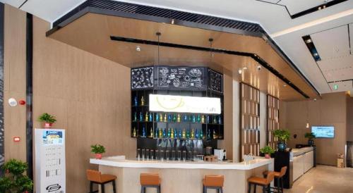 a bar in a restaurant with a lot of wine bottles at Echarm Hotel Changsha Wuyi Square Xiangya Affiliated 1st Provincial Maternity and Child in Changsha