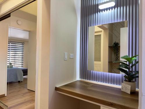 a mirror in a room with a potted plant at Casa Lomas Cozy 3 Bedroom 2 Bath House by Xolos Stadium in Tijuana